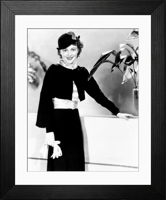Framed Print : Olivia de Havilland, modeling a black-crepe suit with ice-blue satin blouse, 1935