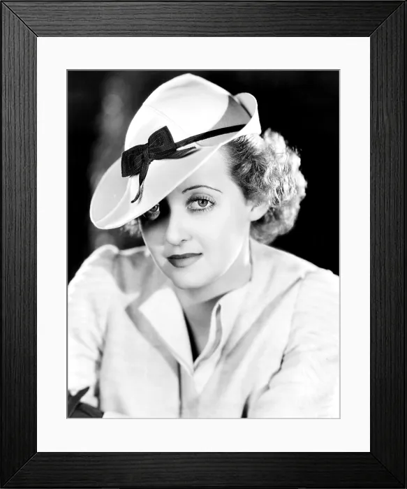 Framed Print : Bette Davis, modeling a snap-brim sports hat of beige felt with a brown grosgrain ribbon, 1937 Framed Print : Bette Davis, modeling a snap-brim sports hat of beige felt with a brown grosgrain ribbon, 1937