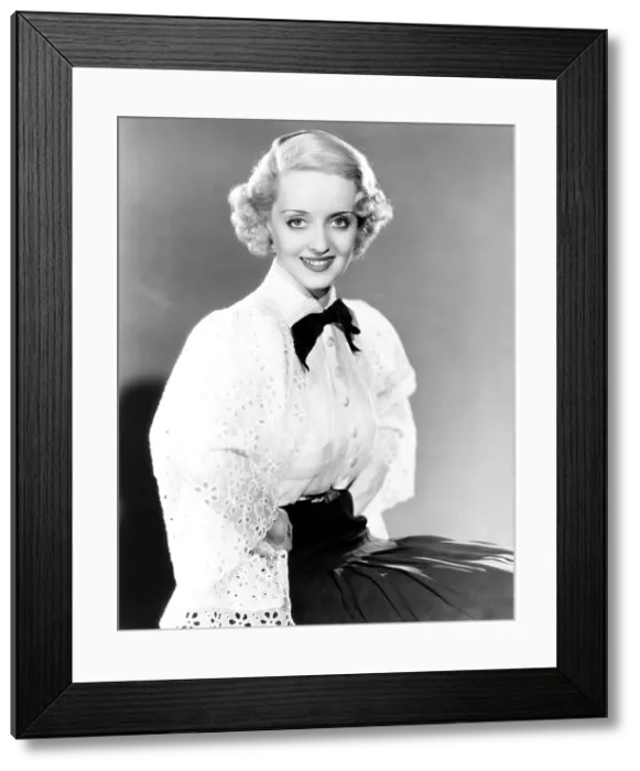 Framed Print : Bette Davis, modeling a white batiste blouse with a black crepe slirt, 1935 Framed Print : Bette Davis, modeling a white batiste blouse with a black crepe slirt, 1935