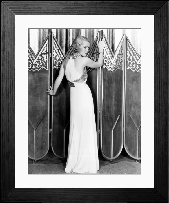 Framed Print : Bette Davis, modeling a white crepe evening gown with a silver sequined bodice sash, 1932