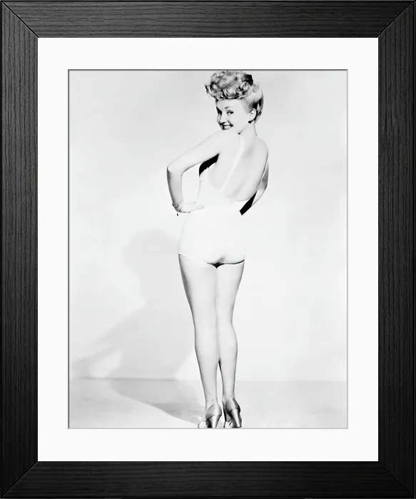 Framed Print : Betty Grable, in a pin-up pose taken by Frank Powolny in 1943 while filming SWEET ROSIE O'GRADY