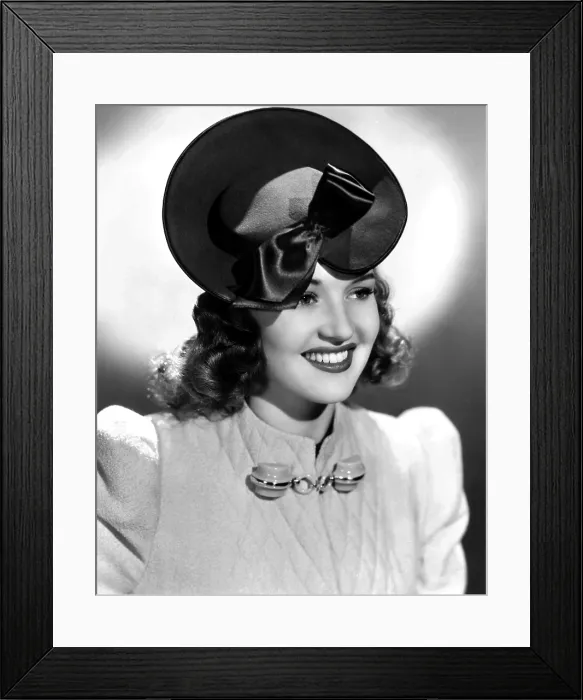 Framed Print : Betty Grable, modeling a tan felt hat with brown satin trim, 1939
