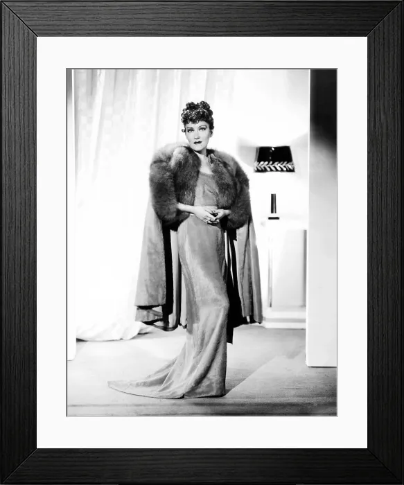 Framed Print : Gloria Swanson, modeling a rose-beige gown of clipped chiffon, with fox trim, ca. 1934