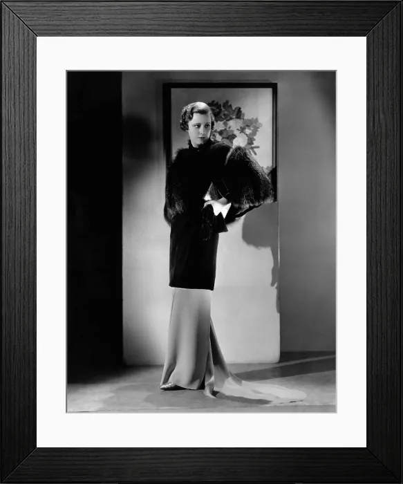Framed Print : Irene Dunne, modeling a sapphire-velvet evening coat trimmed with silver fox, early 1930s