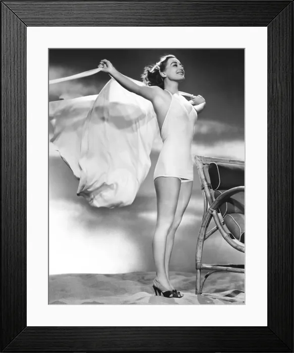 Framed Print : Joan Crawford, in a white wool jersey bathing suit with matching cape, 1938