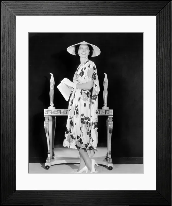 Framed Print : Kay Francis modeling floral-print crepe frock with white accessories from film ANOTHER DAWN, 1937 Framed Print : Kay Francis modeling floral-print crepe frock with white accessories from film ANOTHER DAWN, 1937
