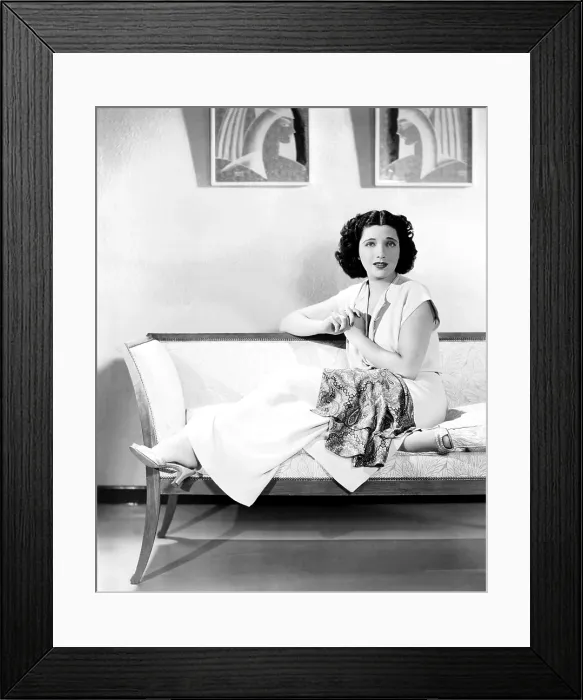 Framed Print : Kay Francis, modeling white crepe lounging pajamas with a paisley sash, ca. mid-1930s Framed Print : Kay Francis, modeling white crepe lounging pajamas with a paisley sash, ca. mid-1930s