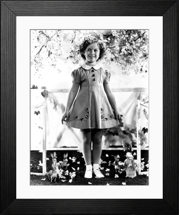 Framed Print : Shirley Temple, modeling a spring frock of shantung with hat-shaped buttons, ca. 1936