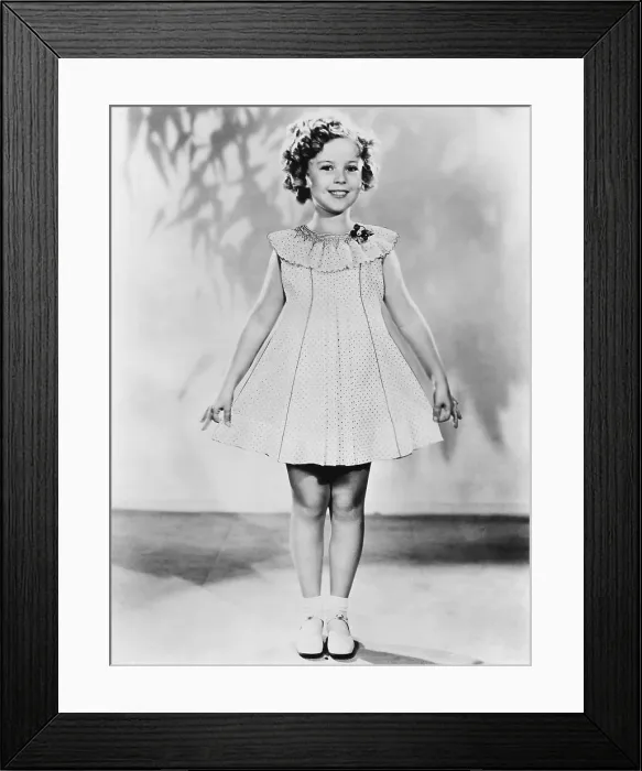 Framed Print : Shirley Temple, modeling a dotted-Swiss dress, ca. 1936