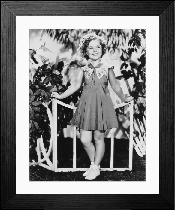 Framed Print : Shirley Temple, modeling a summer frock of handkerchief lawn, ca. 1936