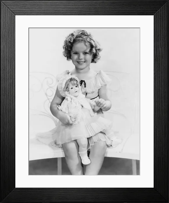 Framed Print : Shirley Temple, with a Shirley Temple doll, ca. 1935