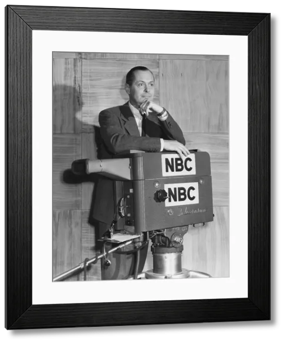 Framed Print : ROBERT MONTGOMERY PRESENTS, Robert Montgomery (host), posing with TV camera, 1950-1957