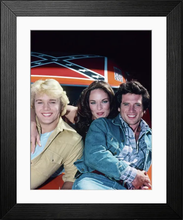 Framed Print : DUKES OF HAZZARD, (from left): John Schneider, Catherine Bach, Tom Wopat, 1979-85 Framed Print : DUKES OF HAZZARD, (from left): John Schneider, Catherine Bach, Tom Wopat, 1979-85