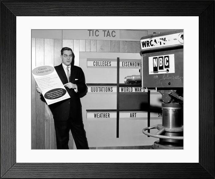Framed Print : TIC TAC DOUGH, host Jack Barry, holding a sign listing Cancer's 7 Danger Signals provided by the American Cancer Society, on set, 1956-1959