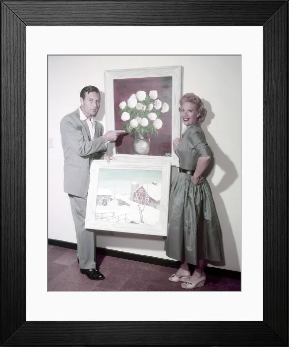 Framed Print : From left: George Montgomery, Dinah Shore (his wife), posing with some of the paintings that she made, circa 1950s Framed Print : From left: George Montgomery, Dinah Shore (his wife), posing with some of the paintings that she made, circa 1950s