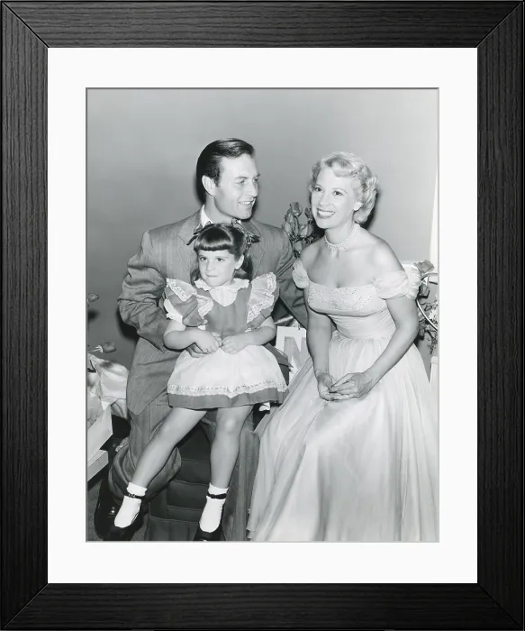 Framed Print : From left: George Montgomery, daughter Melissa Montgomery, wife Dinah Shore, July 1, 1953