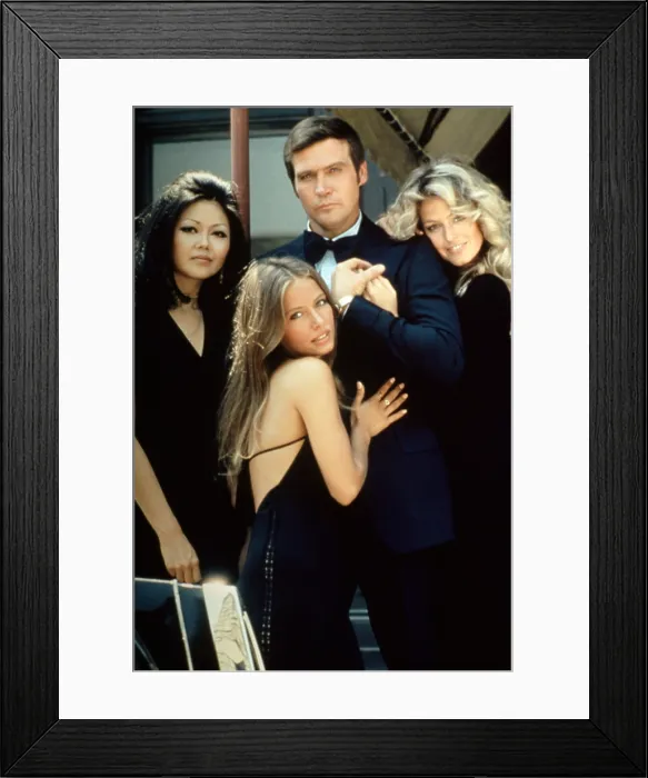 Framed Print : SIX MILLION DOLLAR MAN: WINE WOMEN AND WAR, Lee Majors (center), Farrah Fawcett (right), (publicity photo for tv movie / pilot), 1973