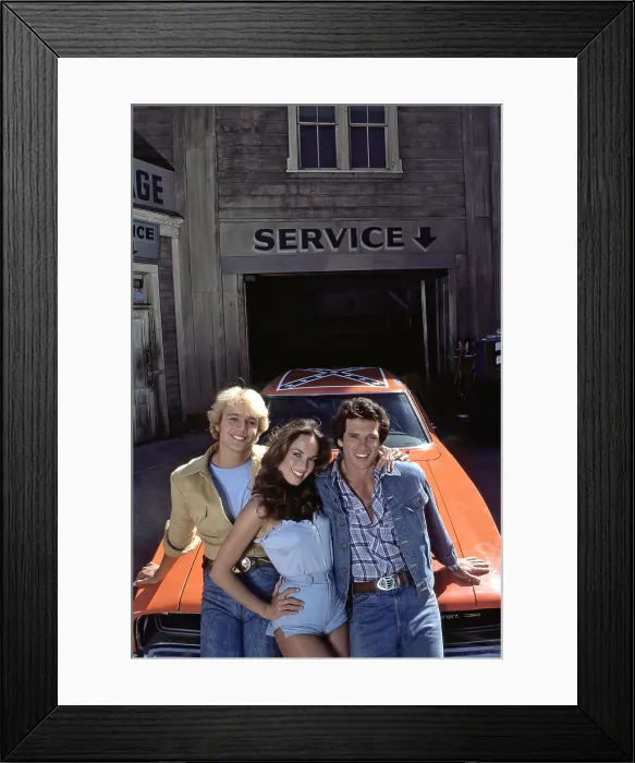 Framed Print : THE DUKES OF HAZZARD, from left: John Schneider, Catherine Bach, Tom Wopat, 1979-1985 Framed Print : THE DUKES OF HAZZARD, from left: John Schneider, Catherine Bach, Tom Wopat, 1979-1985