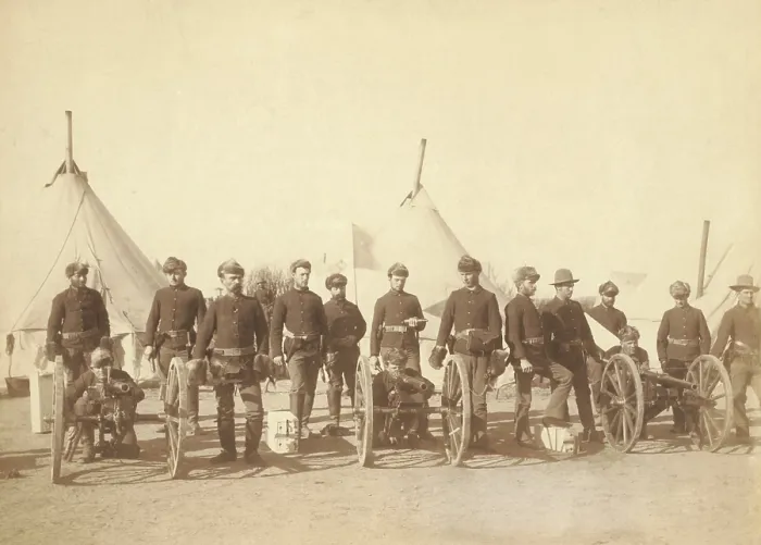 Framed Print : 15 men of Battery E, 1st Artillery, posed with three Hotchkiss guns in their encampment. The original caption of Jan