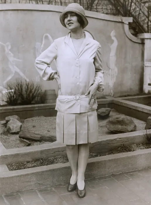 Framed Print : 1927 suit with a mid-knee pleated skirt and matching waistless, hip-belted jacket. The outfit is toped by a cloche hat. March 1927 Framed Print : 1927 suit with a mid-knee pleated skirt and matching waistless, hip-belted jacket. The outfit is toped by a cloche hat. March 1927