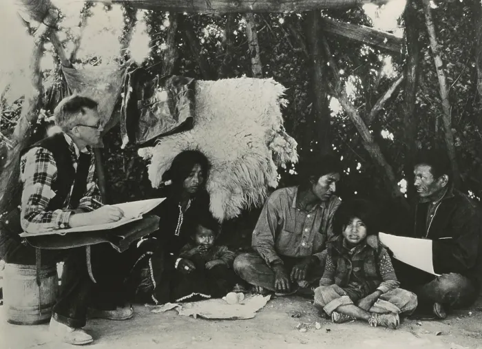Framed Print : 1940 Census taker, seated on a barrel, interviewing a Navajo family. At right is an Indian interpreter to assist communication. (BSLOC_2013_9_5) Framed Print : 1940 Census taker, seated on a barrel, interviewing a Navajo family. At right is an Indian interpreter to assist communication. (BSLOC_2013_9_5)
