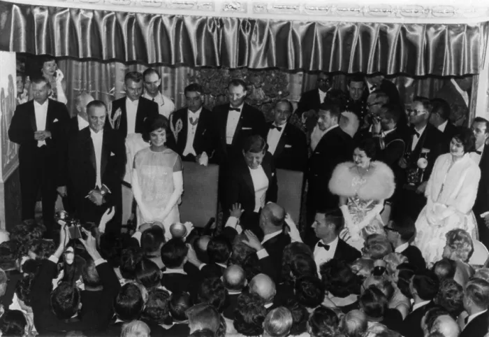 Framed Print : 1960 Inaugural Ball. President Kennedy reaching down to shake hands with a guest at the Mayflower Hotel