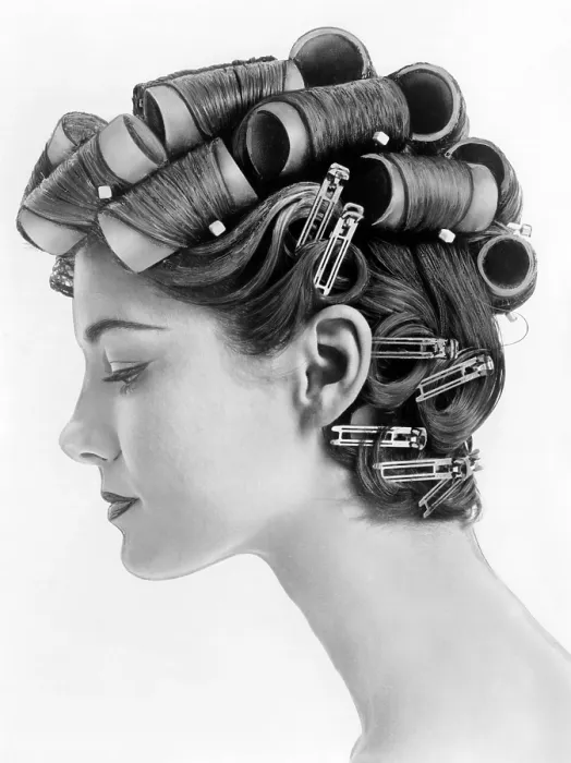 Framed Print : 1960s bouffant hair styles were created with big rollers on top of the head and pin curls to create a soft flip up at the neck. Profile view. June 25, 1962 Framed Print : 1960s bouffant hair styles were created with big rollers on top of the head and pin curls to create a soft flip up at the neck. Profile view. June 25, 1962