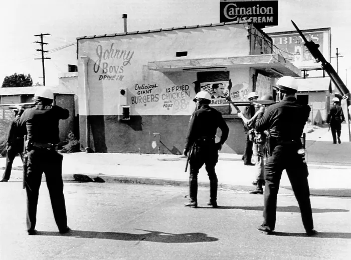 Framed Print : 1965 Watts Riot. Police and National Guardsmen hold guns ready as the sweep down San Pedro Street in a major riot torn area in Southeast Los Angeles. August 14, 1965