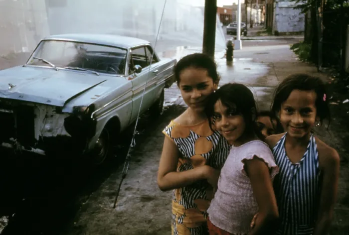Framed Print : 1970s America. Three young girls pose in front of an abandoned car in Brooklyn, New York City, ca. 1973