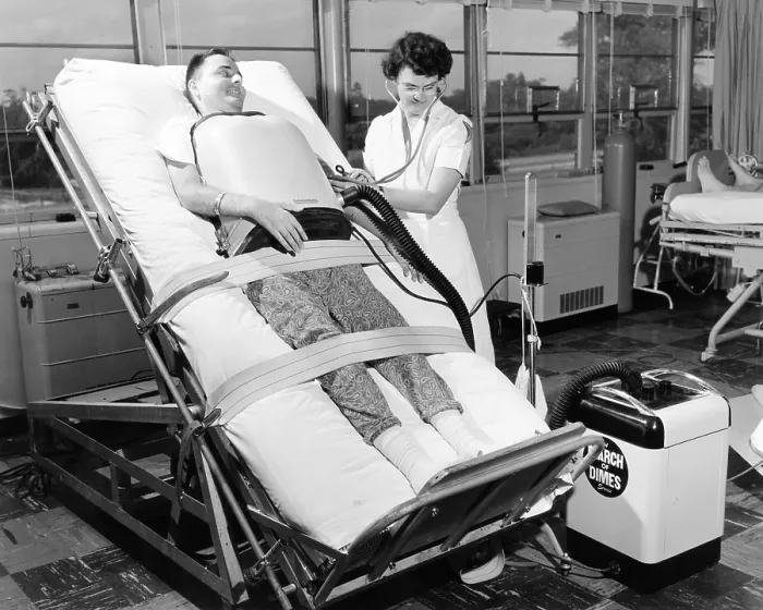 Framed Print : A 30 year old polio patient wearing a chest respirator on a standing bed. This relieves pressure on the back from the horizontal bed of iron lungs
