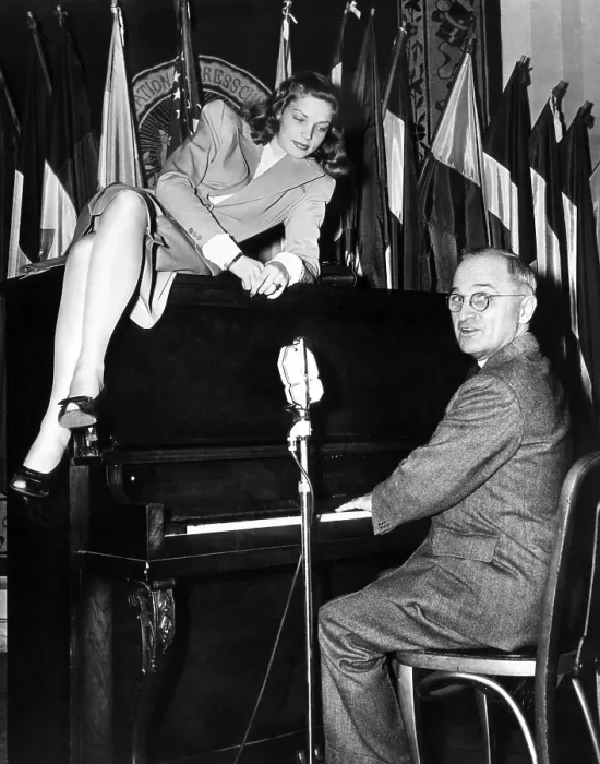 Framed Print : Actress Lauren Bacall sits atop the piano while Vice President Harry Truman plays Framed Print : Actress Lauren Bacall sits atop the piano while Vice President Harry Truman plays