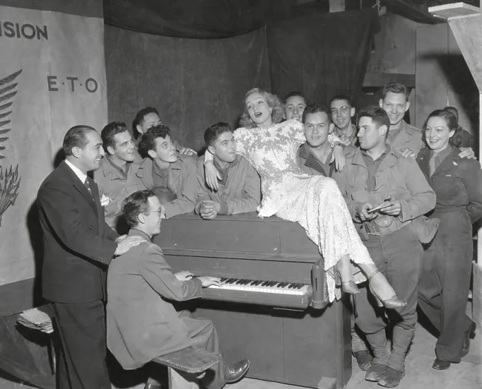 Framed Print : Actress Marlene Dietrich singing for a group of GI's in France. Joey Faye (left), and Jerry Cummings, pianist, accompanied Miss Dietrich, Oct. 18, 1844. (BSLOC_2014_8_206)