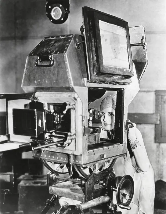 Framed Print : Actress Norma Shearer inspects a sound proof camera. It eliminated the need of the unwieldy booths and permitted the same sweep of the camera action as in silent pictures. Aug