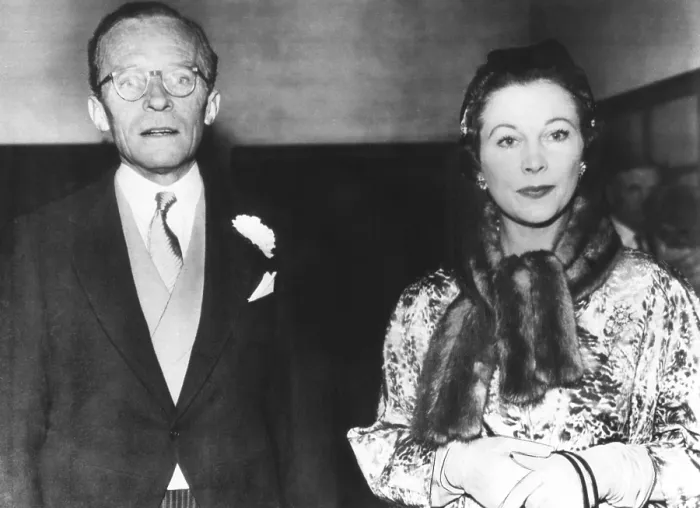 Framed Print : Actress Vivien Leigh with her former husband, Leigh Holman, at the wedding of their daughter. Suzanne Holman married Robin Farrington at Holy Trinity Church, London, Dec. 6, 1957 Framed Print : Actress Vivien Leigh with her former husband, Leigh Holman, at the wedding of their daughter. Suzanne Holman married Robin Farrington at Holy Trinity Church, London, Dec. 6, 1957