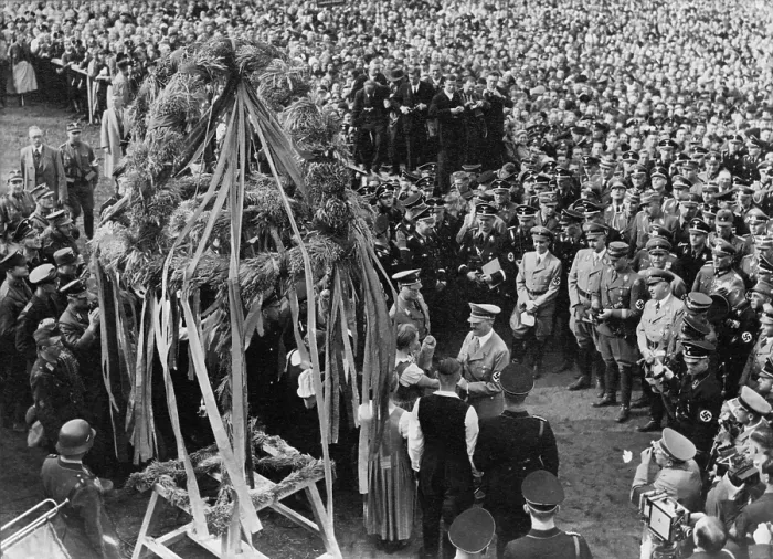 Framed Print : Adolf Hitler at the Erntedanktag (harvest thanksgiving festival). Nazi leaders are greeted by a young woman at Buckeberg, Germany. Oct 3, 1937. (BSLOC_2013_11_23)