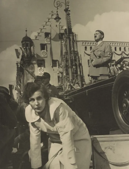 Framed Print : Adolf Hitler standing in an open automobile, with Leni Riefenstahl foreground, facing the camera