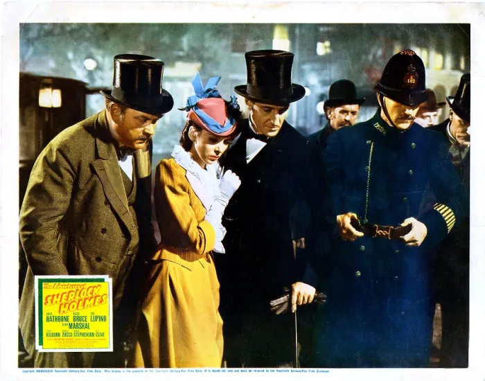 Framed Print : THE ADVENTURES OF SHERLOCK HOLMES, US lobbycard, Nigel Bruce (left), Ida Lupino (yellow dress), Basil Rathbone (tuxedo), 1939, TM and copyright 20th Century Fox Film Corp