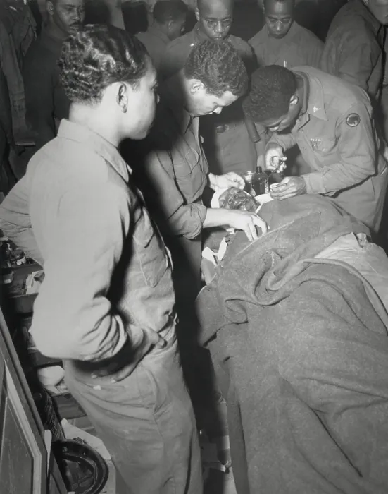 Framed Print : African American Army surgeon stitches face and shoulder wounds in the Pietrasanta Area, Italy. Feb. 10, 1945. Capt. Ezekia Smith, 370th Inf. Regt. 92nd Div