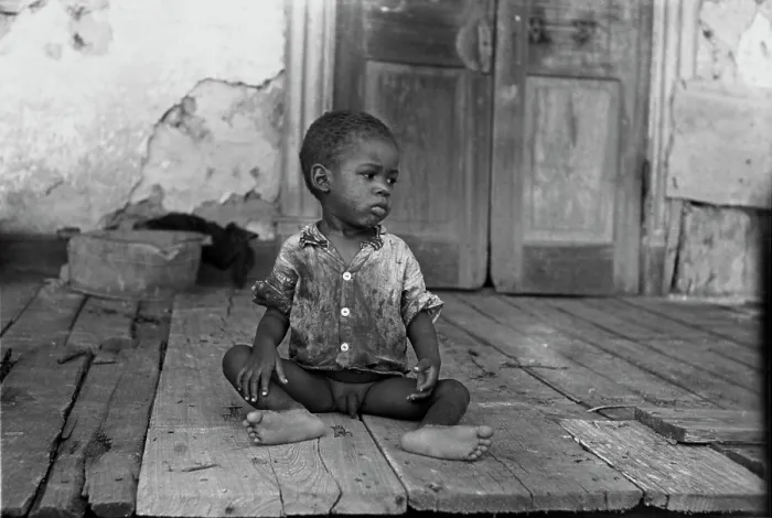 Framed Print : African American child on a dilapidated porch, original title: Negro child on porch of dilapidated Trepagnier plantation near Norco, Louisiana