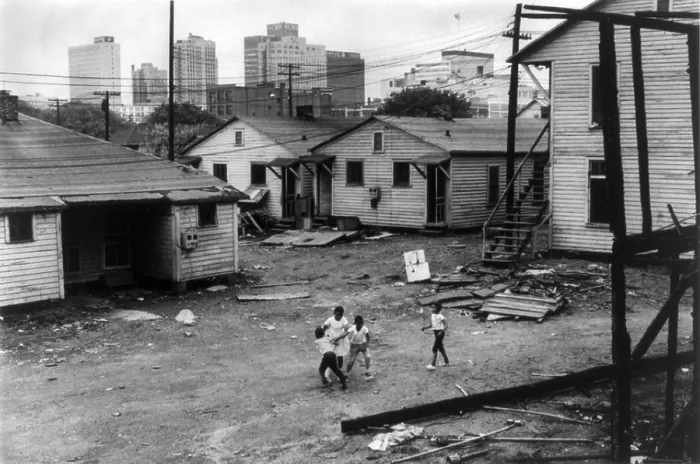 Framed Print : African American children playing in slum in view of high rise buildings in background. North Carolina, ca. 1966