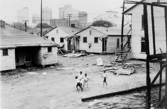 Framed Print : African American children playing in slum in view of high rise buildings in background. North Carolina, ca. 1966 Framed Print : African American children playing in slum in view of high rise buildings in background. North Carolina, ca. 1966