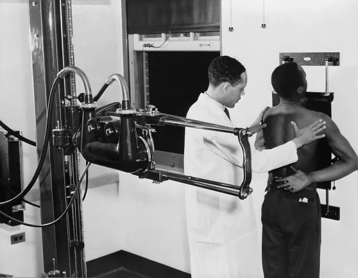 Framed Print : African American doctor placing patient in the correct position for taking chest x-ray for use in the diagnosis in 1937 Framed Print : African American doctor placing patient in the correct position for taking chest x-ray for use in the diagnosis in 1937