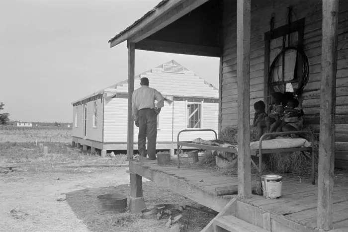 Framed Print : African American farm worker, looking at a new home from his shack, May 1938. At Southeast Missouri Farms, a New Deal Resettlement Administration project. (BSLOC_2013_7_53)