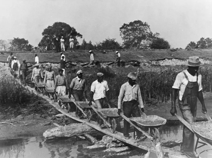 Framed Print : Fifteen African American laborers with wheel barrels hauling dirt to build a levee in Louisiana in 1935 as four whites supervise and watch the workers. 1935 photo by Ben Shahn Framed Print : Fifteen African American laborers with wheel barrels hauling dirt to build a levee in Louisiana in 1935 as four whites supervise and watch the workers. 1935 photo by Ben Shahn
