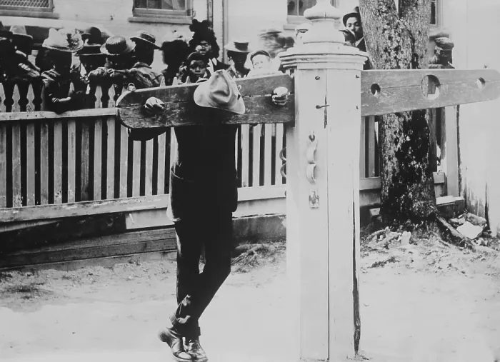 Framed Print : African American man with his neck and hands immobilized in punishment pillory, Delaware, c. 1900-1920 Framed Print : African American man with his neck and hands immobilized in punishment pillory, Delaware, c. 1900-1920