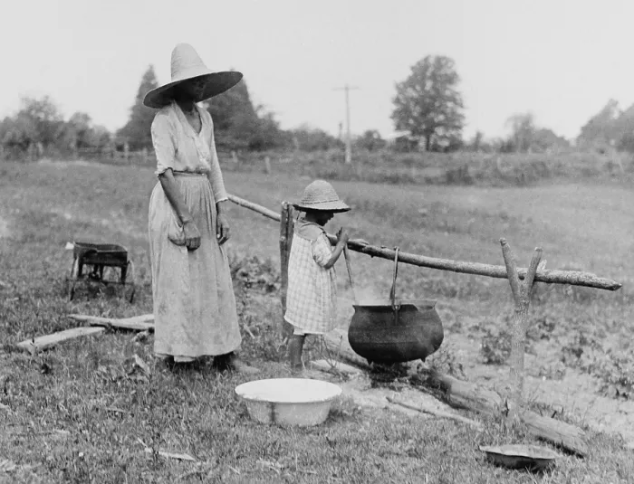 Framed Print : African American mother and daughter boiling water over an outside fire. Colonial Beach, Virginia, 1920. (BSLOC_2015_16_126)