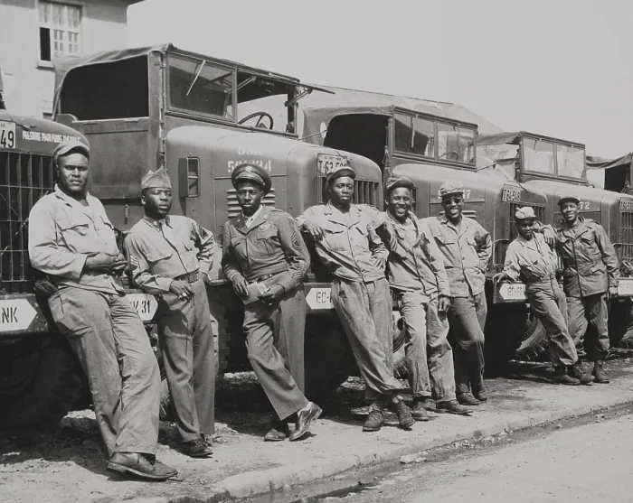 Framed Print : African American officers and mechanics standing in front of Army trucks