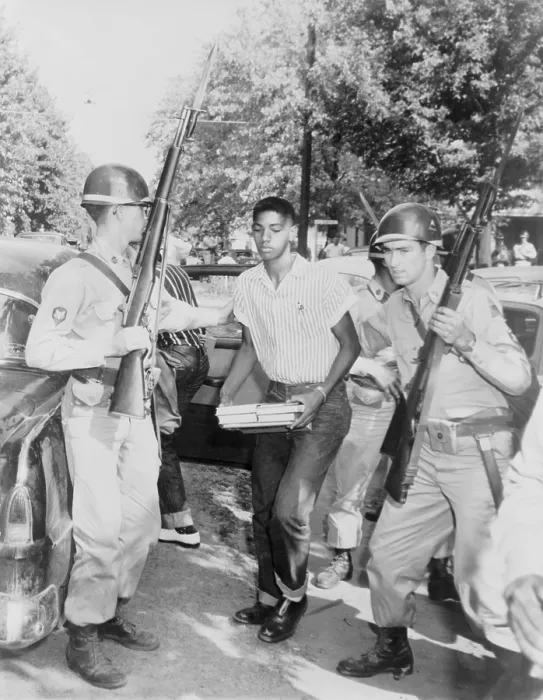 Framed Print : An African American student is escorted to a waiting car by National Guard troops enforcing school integration in Sturgis, Kentucky. Sept 1956 Framed Print : An African American student is escorted to a waiting car by National Guard troops enforcing school integration in Sturgis, Kentucky. Sept 1956