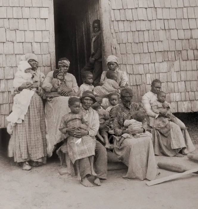 Framed Print : African American women, children, and one man seated outside a wood-shingled building, c. 1895 Framed Print : African American women, children, and one man seated outside a wood-shingled building, c. 1895