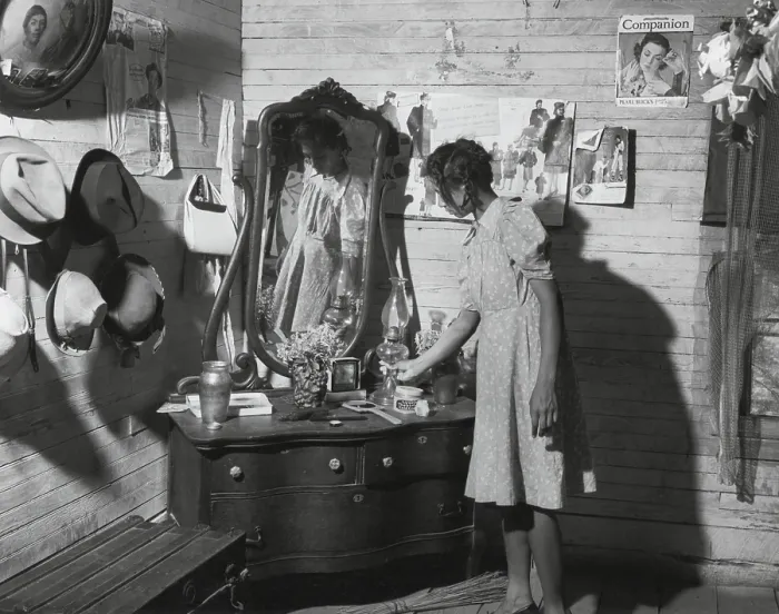 Framed Print : African American women at her dressing table in Putman, Georgia, 1941. The walls are decorated with family portraits and magazine advertisements. (BSLOC_2013_8_124)